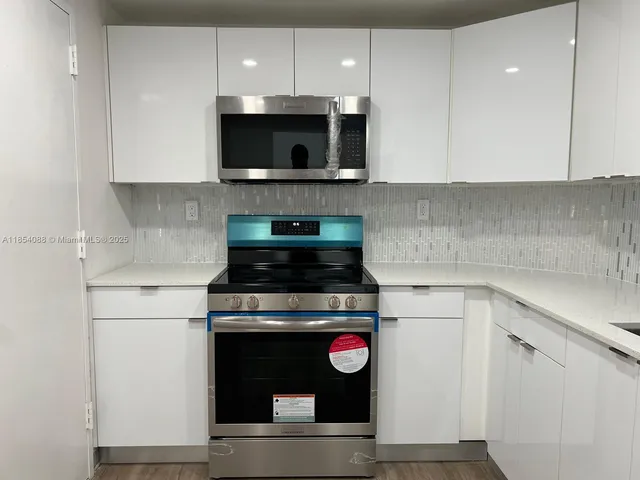 a kitchen with a stove and a microwave