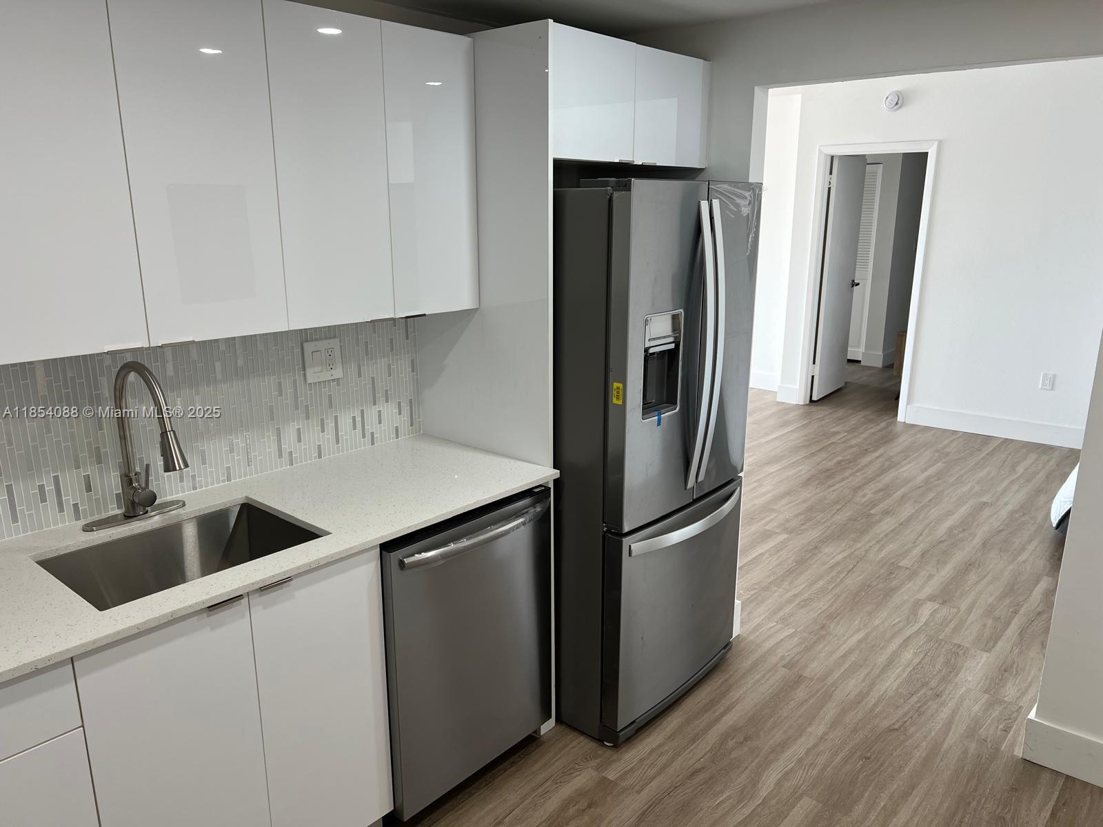 500 Bayview Drive, Unit 1120 Sunny Isles Beach, FL 33160 - Photo 6 of 46 a kitchen with stainless steel appliances granite countertop a refrigerator and a sink
