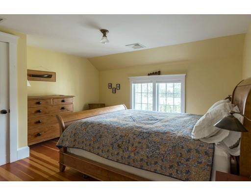 7 Labor In Vain Road Ipswich, MA 01938 - Photo 16 of 30 a bedroom with a bed and wooden floor