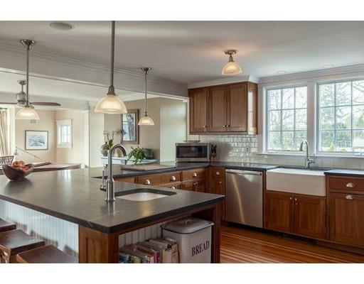 7 Labor In Vain Road Ipswich, MA 01938 - Photo 4 of 30 a kitchen with kitchen island a sink counter top space appliances and cabinets