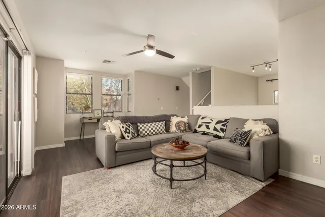 a view of a workspace with furniture and a window