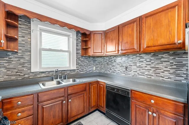 a kitchen with stainless steel appliances a sink stove and cabinets
