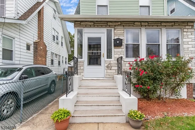 a view of a house with more windows and flower plants