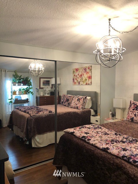 15280 Maple Drive Renton, WA 98058 - Photo 14 of 17 a bedroom with a large bed and a chandelier