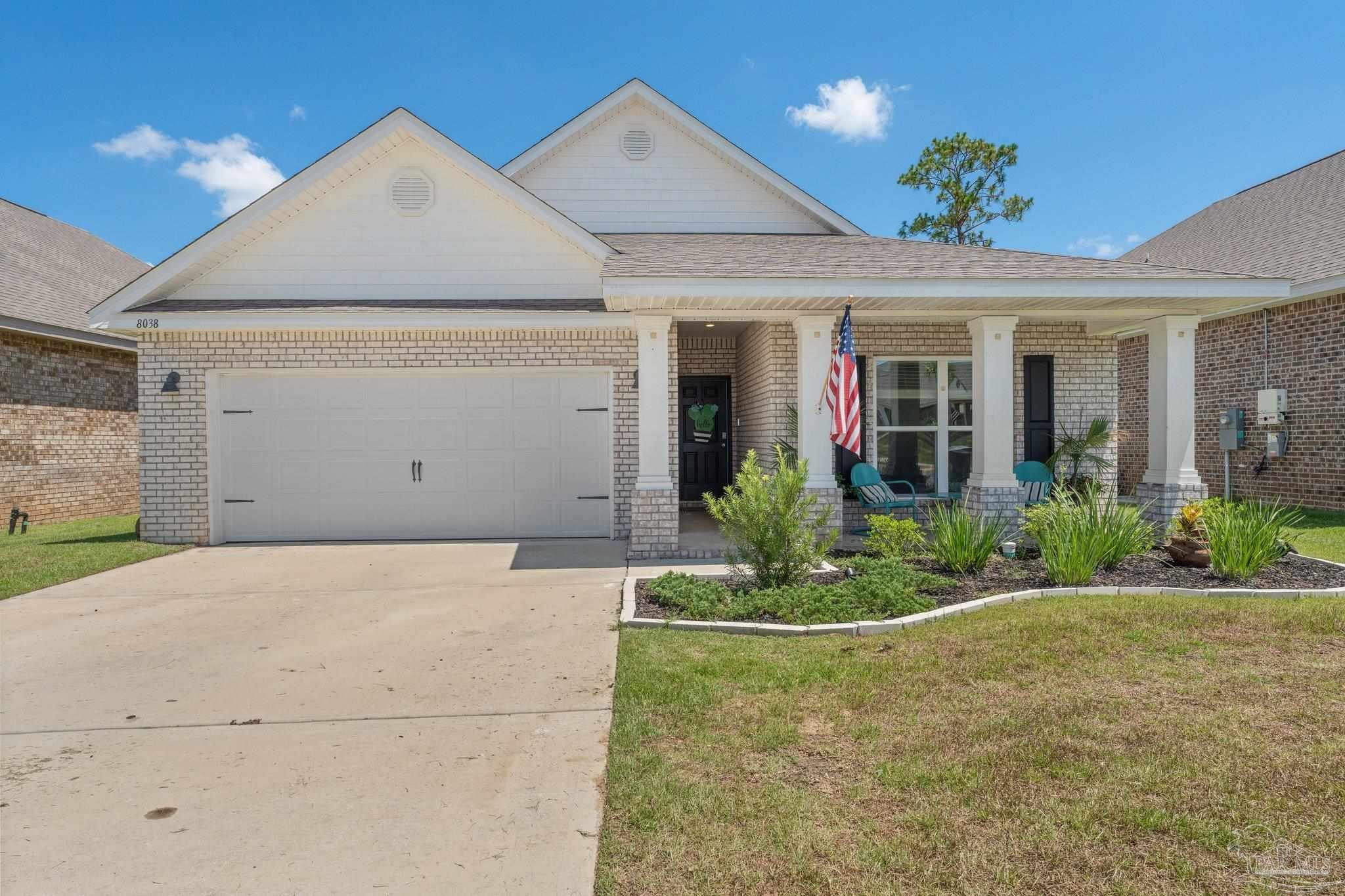 a view of a house with potted plants