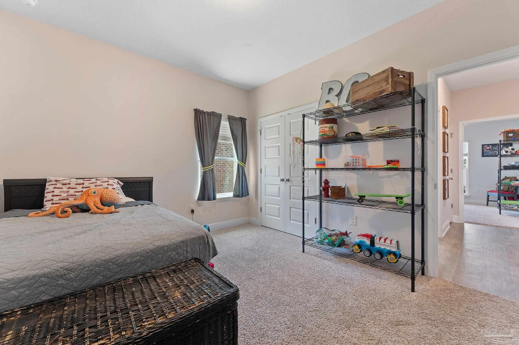 8038 Burnside Loop Pensacola, FL 32526 - Photo 11 of 44 a bedroom with bed and walk in closet