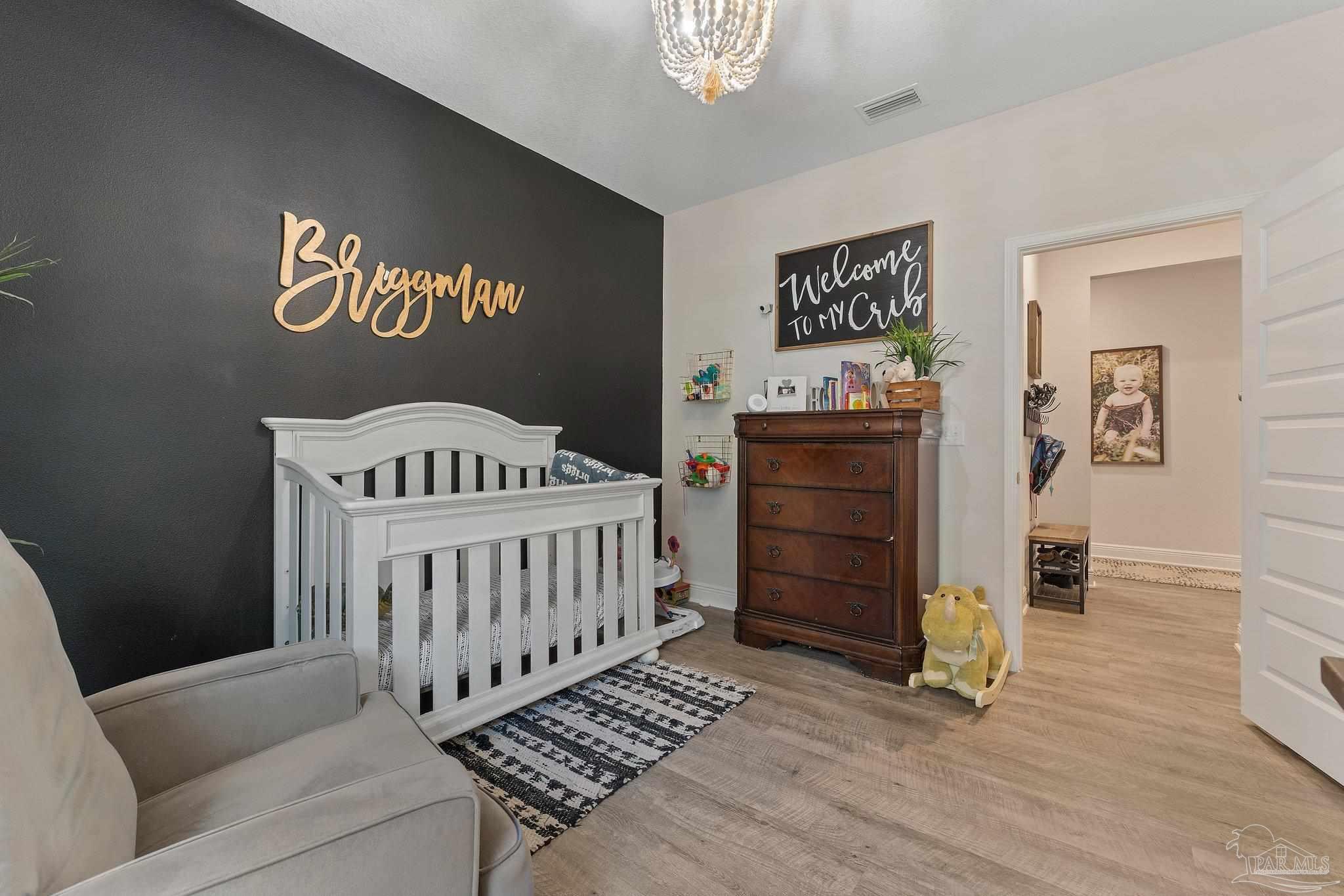 8038 Burnside Loop Pensacola, FL 32526 - Photo 13 of 44 a bedroom with furniture and wooden floor