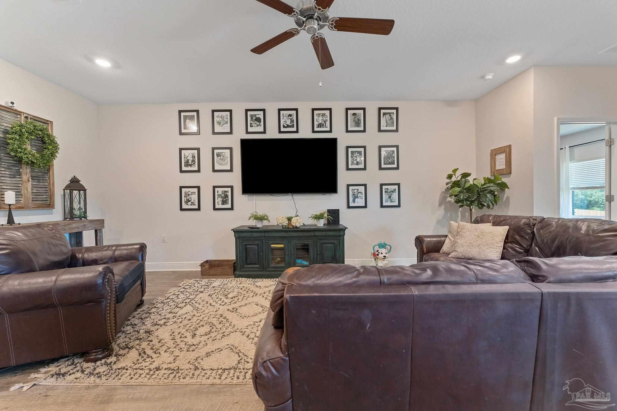 8038 Burnside Loop Pensacola, FL 32526 - Photo 16 of 44 a living room with furniture and a flat screen tv