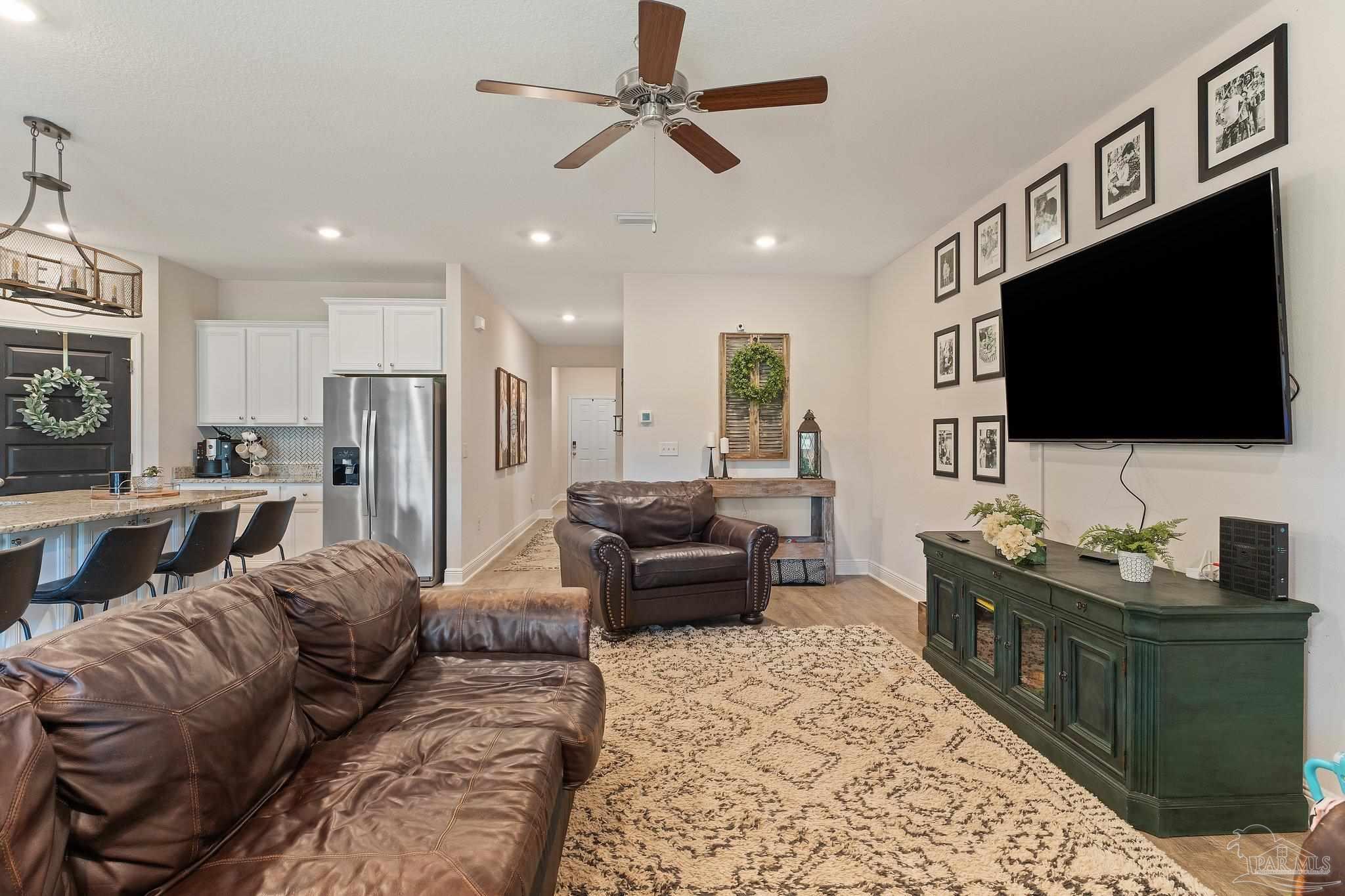8038 Burnside Loop Pensacola, FL 32526 - Photo 18 of 44 a living room with furniture and a flat screen tv