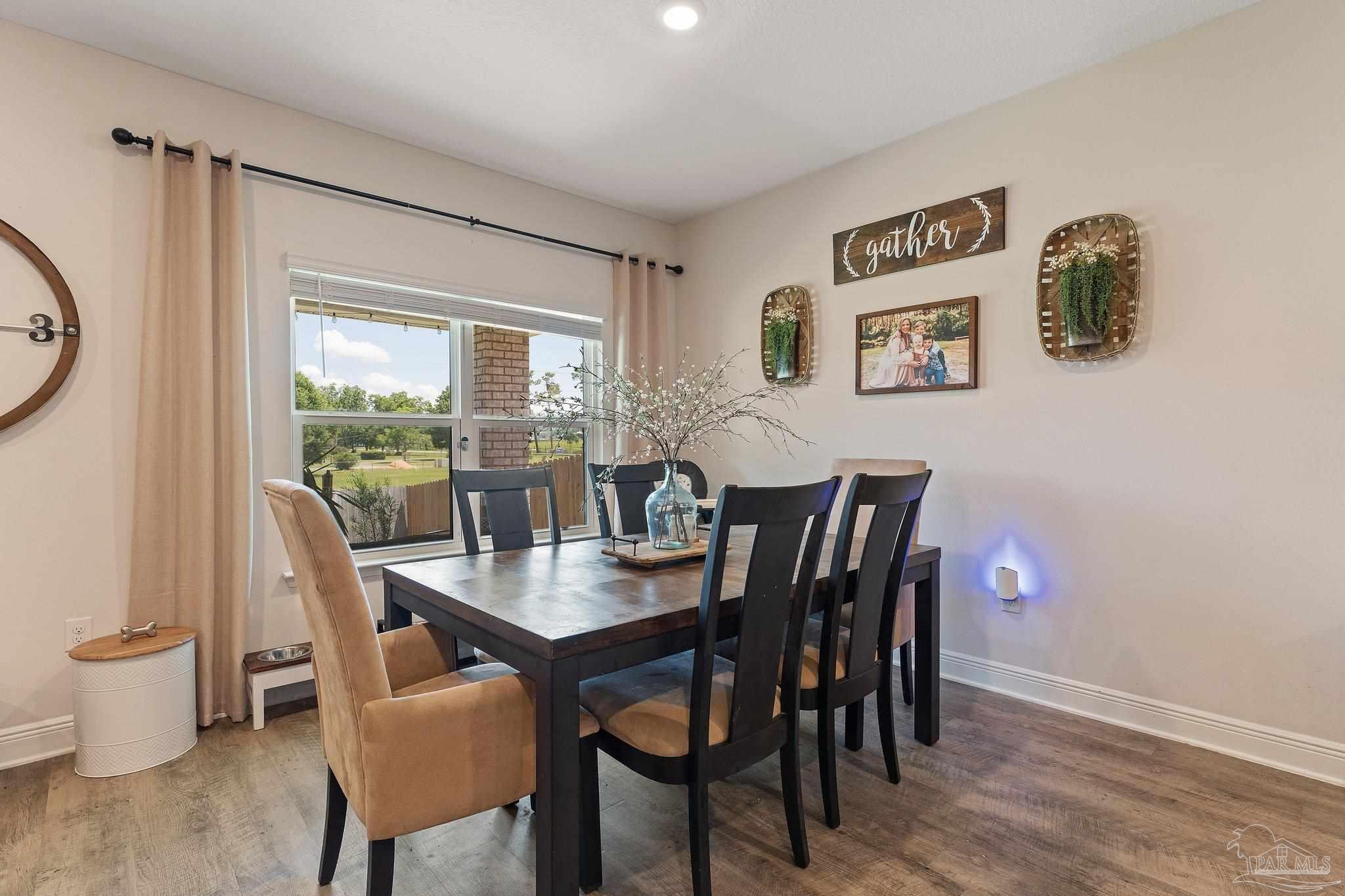 8038 Burnside Loop Pensacola, FL 32526 - Photo 19 of 44 a view of a dining room with furniture window and wooden floor
