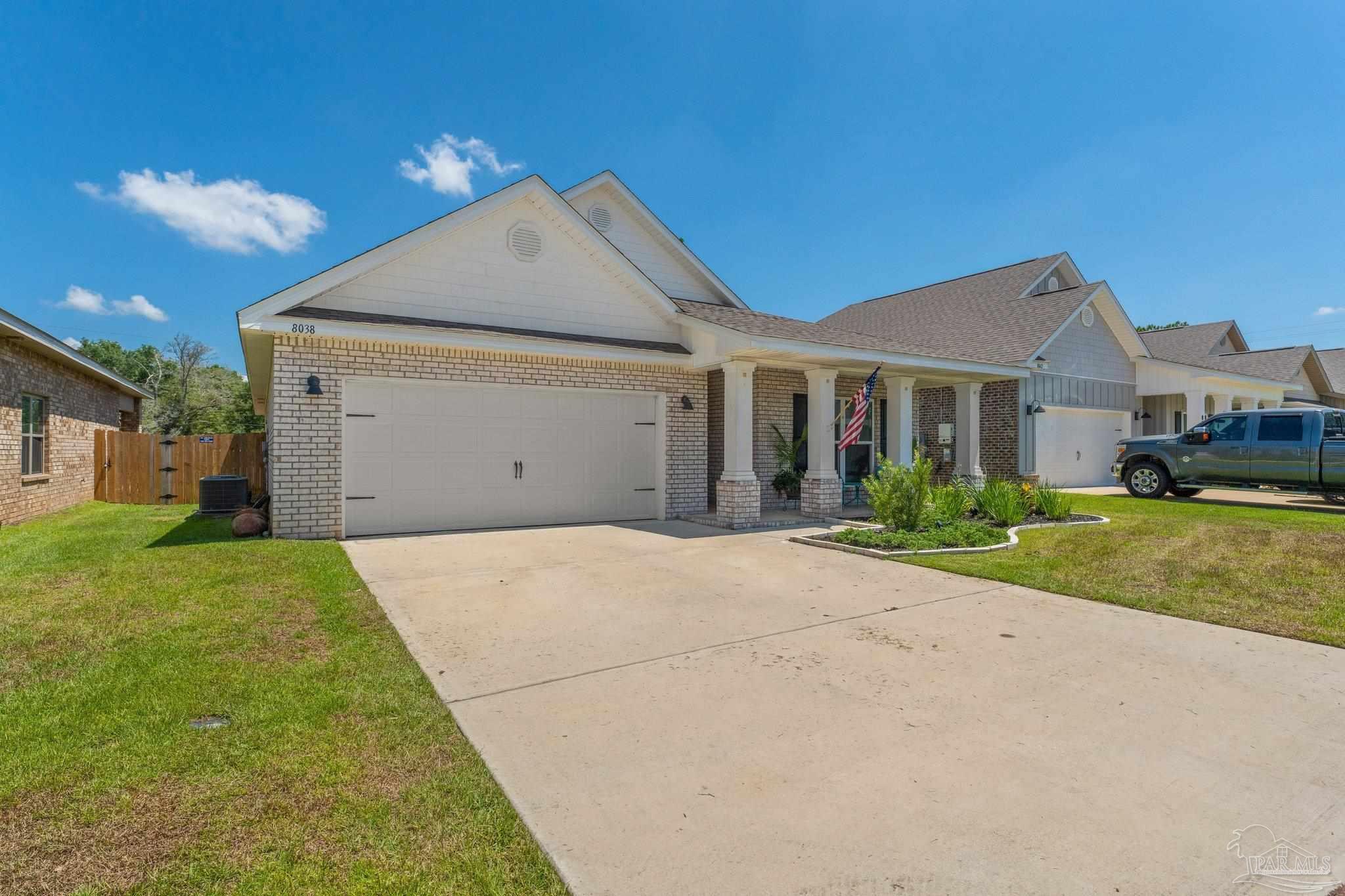 8038 Burnside Loop Pensacola, FL 32526 - Photo 2 of 44 a front view of a house with a yard and garage