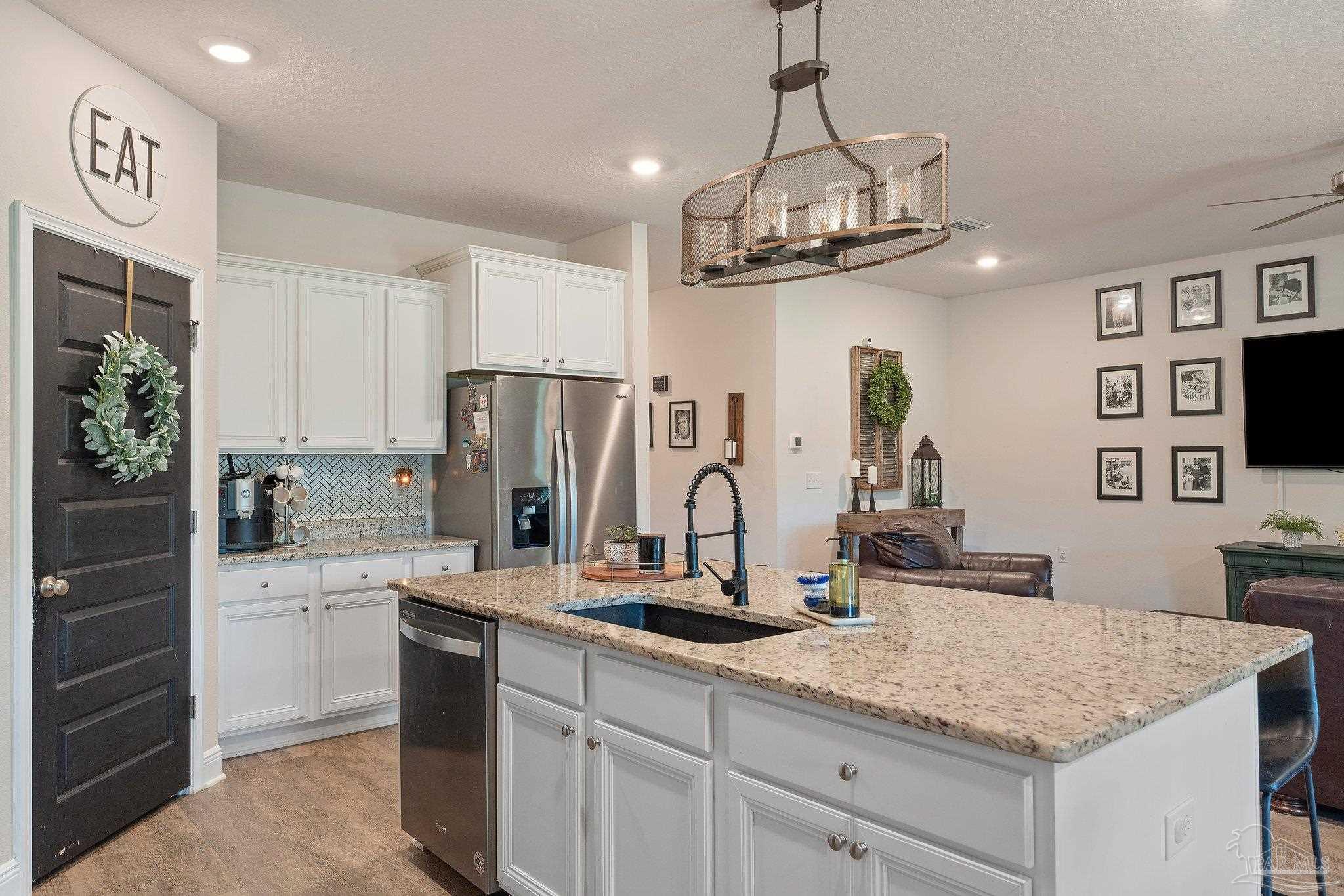 8038 Burnside Loop Pensacola, FL 32526 - Photo 21 of 44 a kitchen with stainless steel appliances granite countertop a sink refrigerator and cabinets