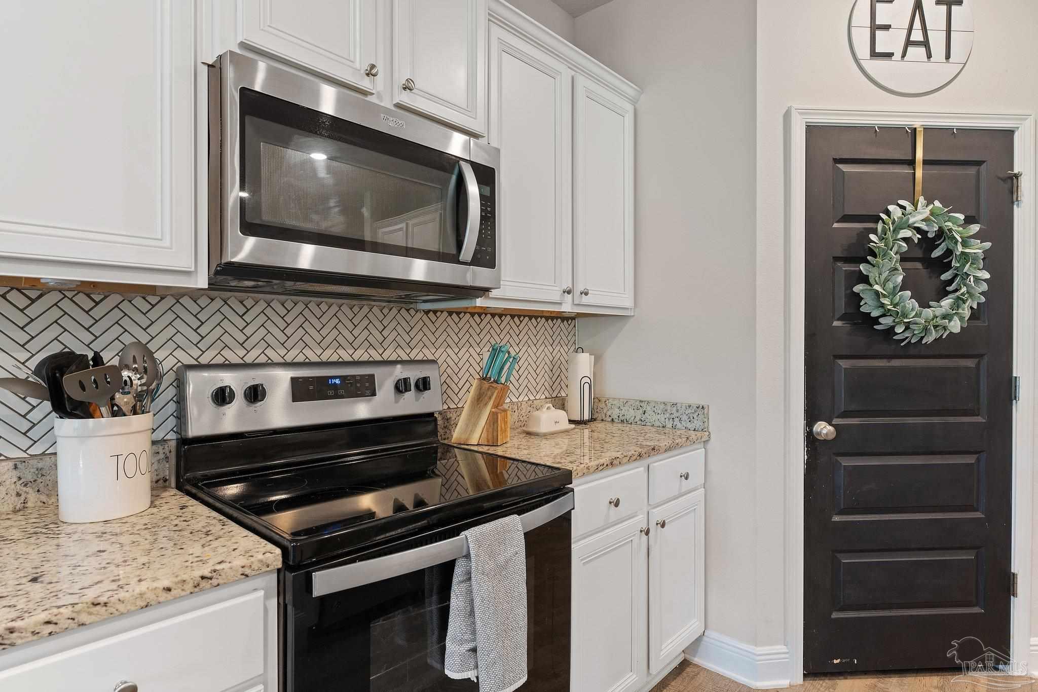 8038 Burnside Loop Pensacola, FL 32526 - Photo 24 of 44 a kitchen with a stove and a microwave