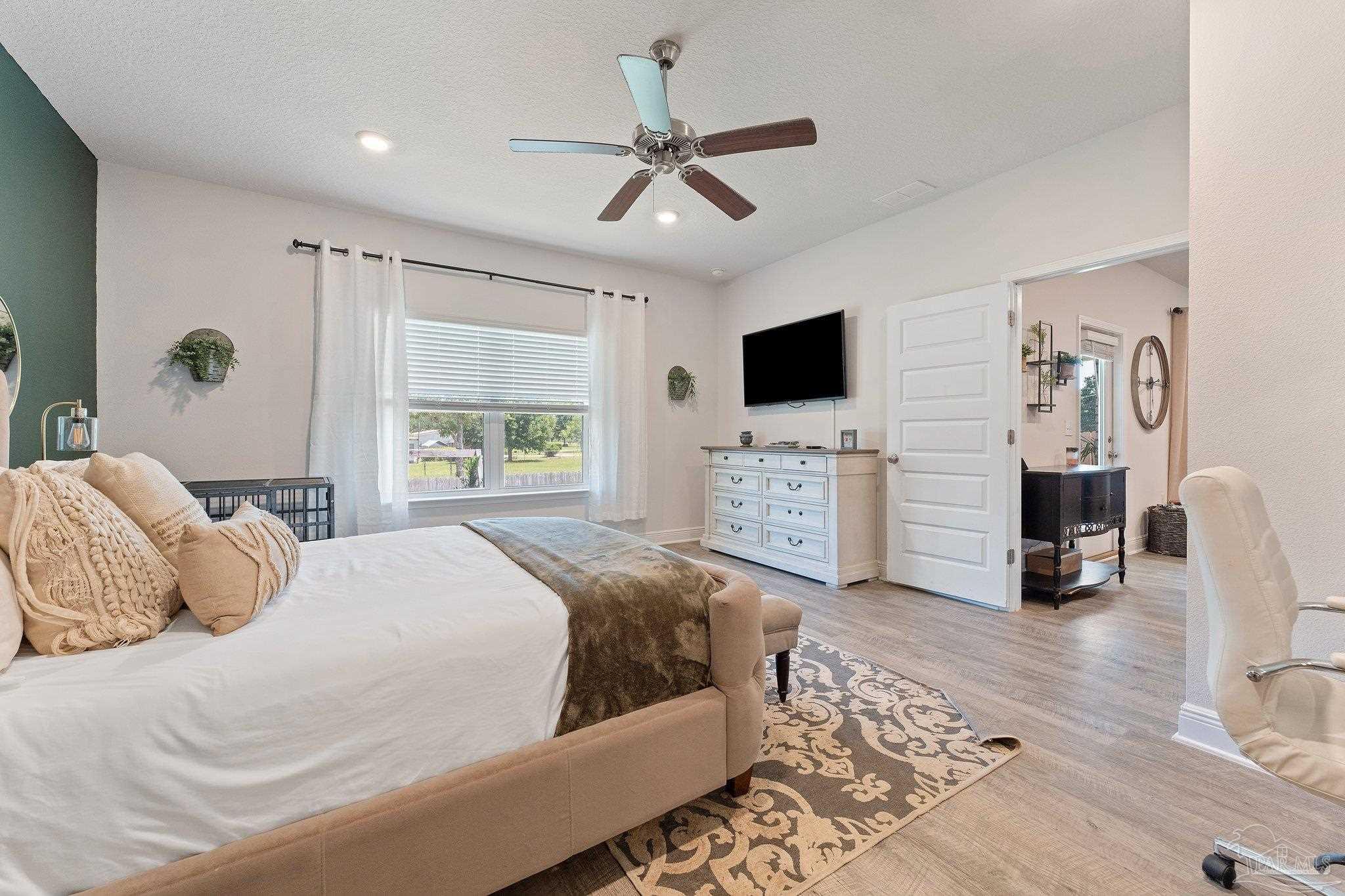 8038 Burnside Loop Pensacola, FL 32526 - Photo 27 of 44 a bedroom with a bed window and a flat screen tv