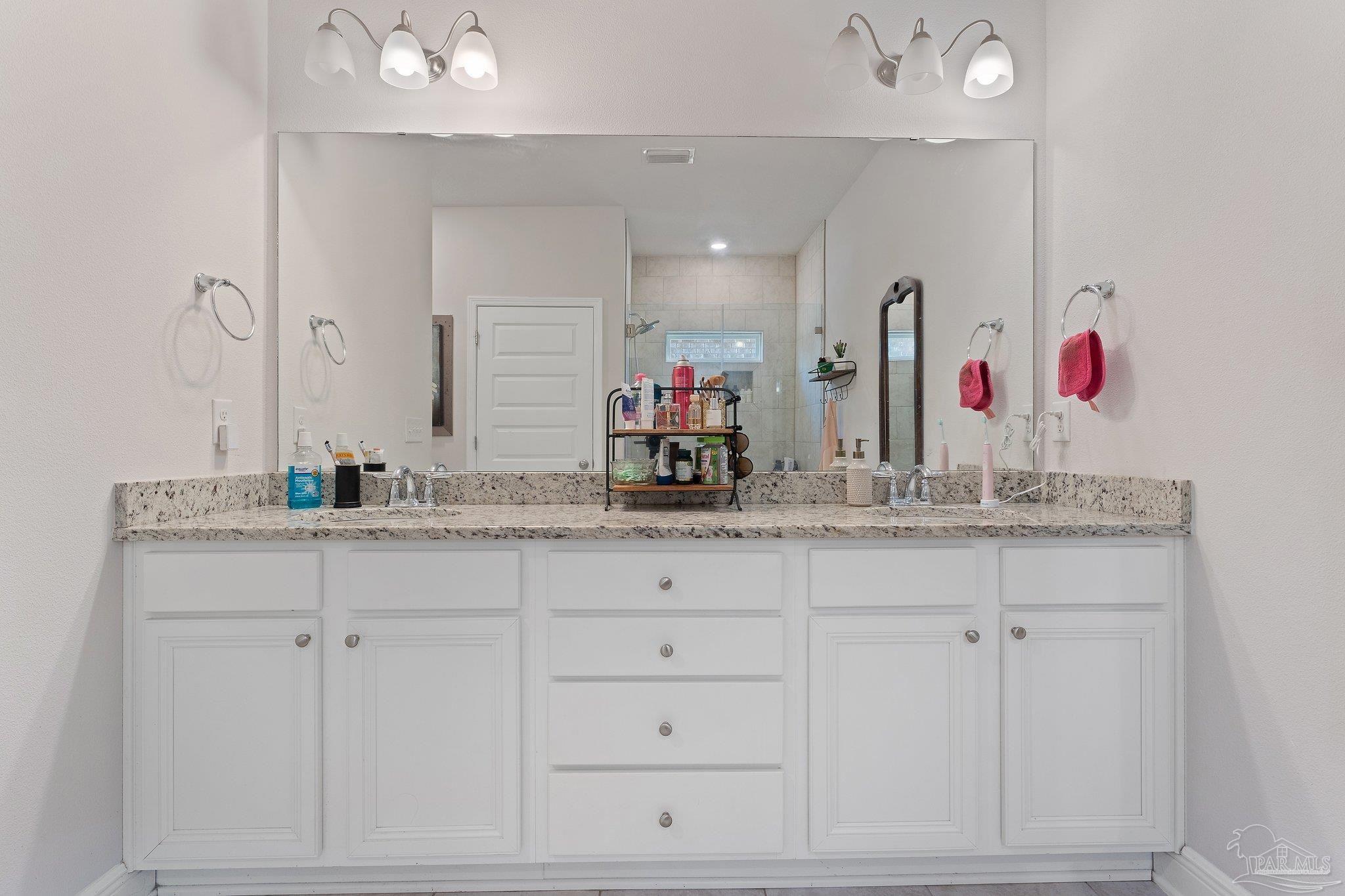 8038 Burnside Loop Pensacola, FL 32526 - Photo 29 of 44 a bathroom with sinks mirror and vanity