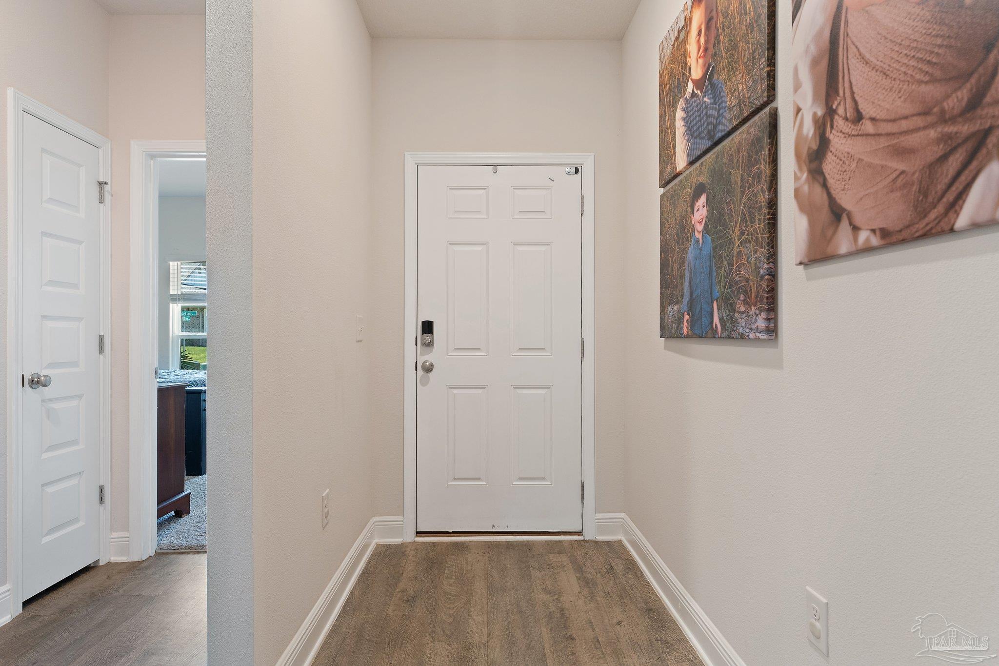 8038 Burnside Loop Pensacola, FL 32526 - Photo 6 of 44 a view of a hallway with wooden floor and closet