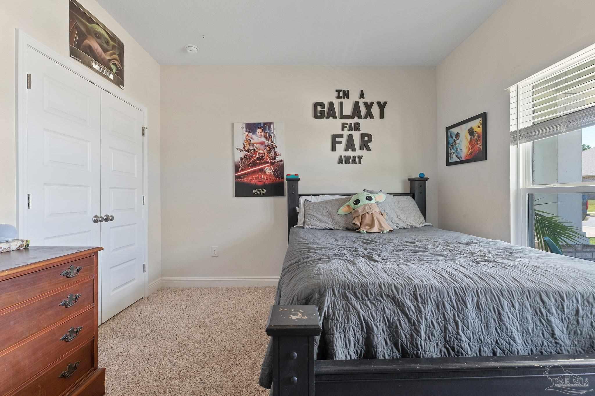 8038 Burnside Loop Pensacola, FL 32526 - Photo 8 of 44 a bedroom with a bed and painting on the wall