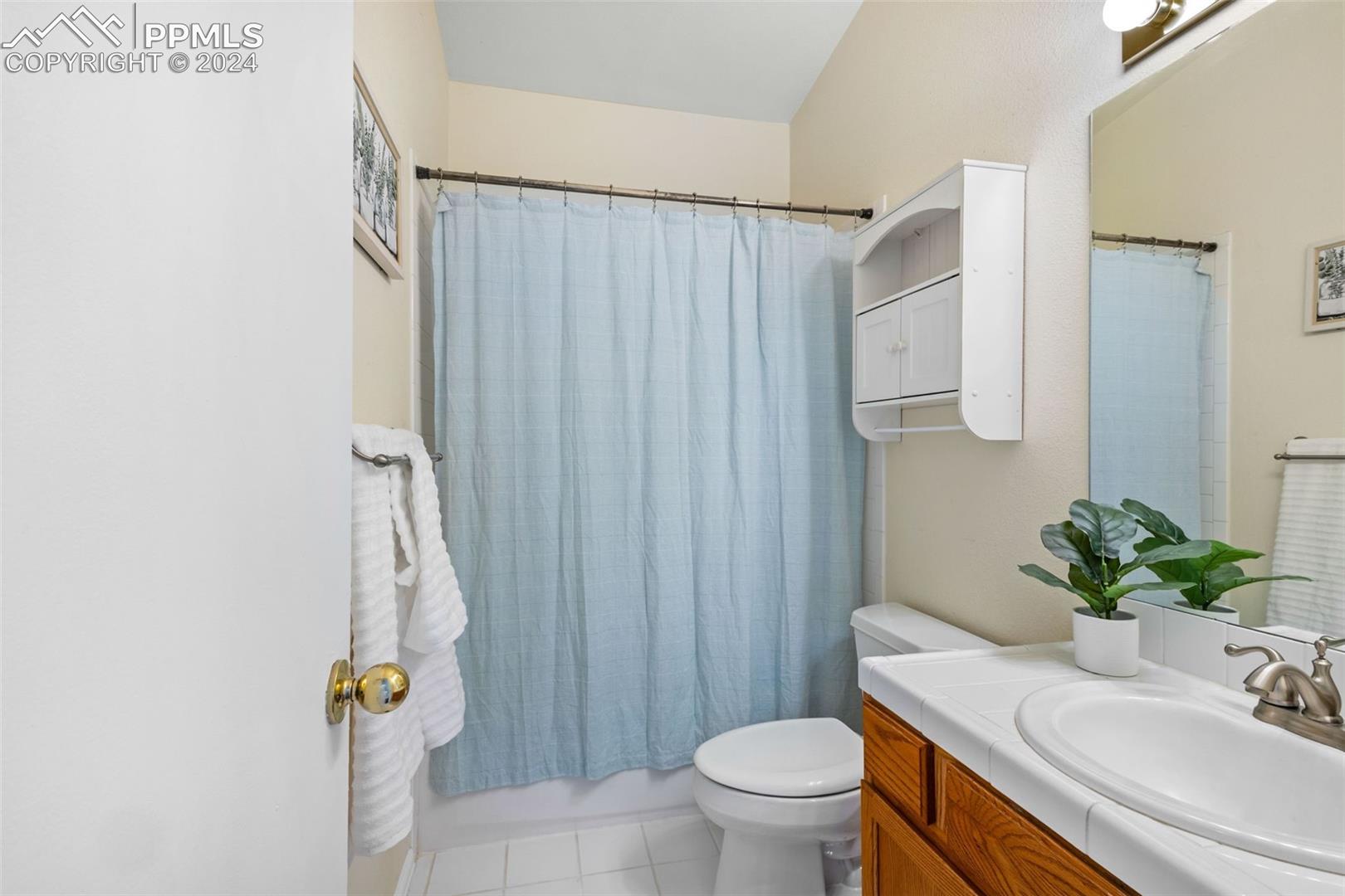 17650 Fremont Fort Road Peyton, CO 80831 - Photo 19 of 41 Bathroom featuring tile flooring, toilet, and vanity