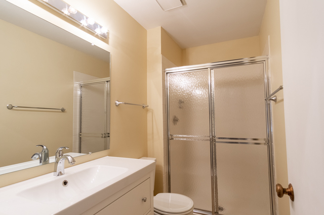 2610 Northampton Drive, Unit B1 Rolling Meadows, IL 60008 - Photo 12 of 16 a bathroom with a sink toilet and shower