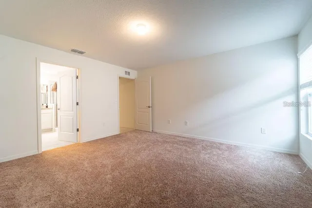 a bathroom with a tub a sink and a mirror