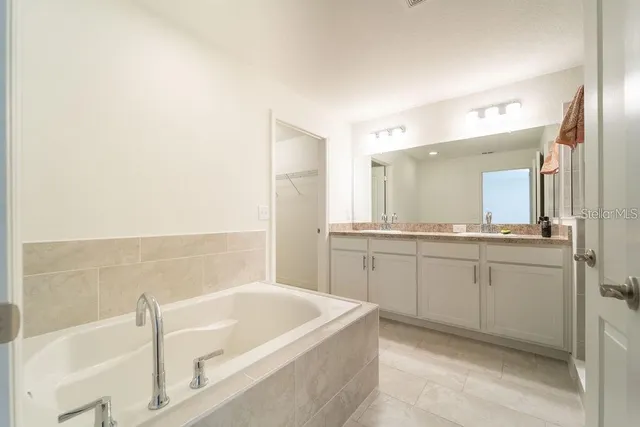 a bath tub sitting next to a bathroom sink