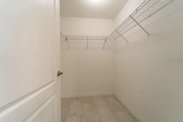 a white toilet sitting next to a white wall