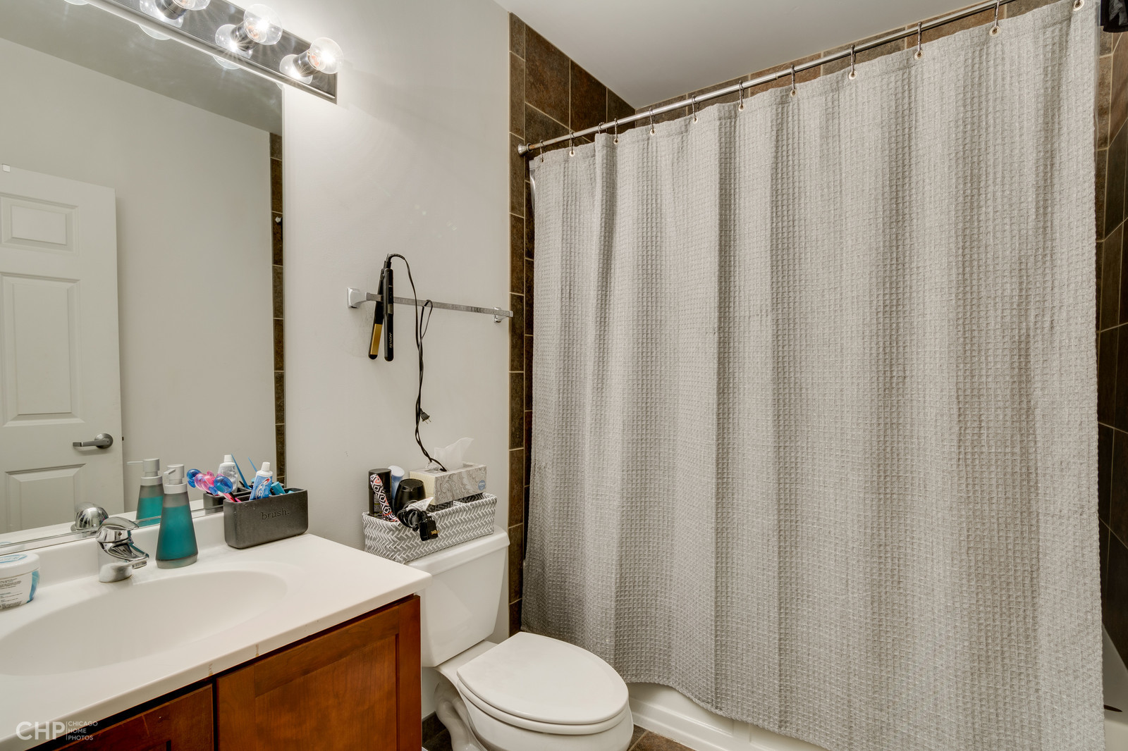 8 West Monroe Street, Unit 905 Chicago, IL 60603 - Photo 14 of 17 a bathroom with a sink vanity mirror and toilet