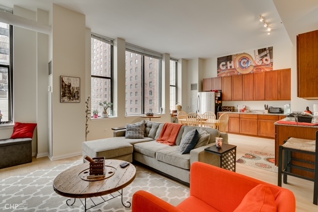 8 West Monroe Street, Unit 905 Chicago, IL 60603 - Photo 2 of 17 a living room with furniture kitchen view and a window