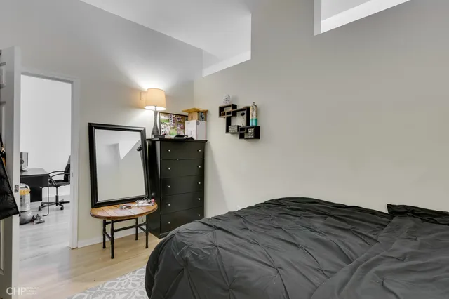 a bedroom with a bed and cabinets