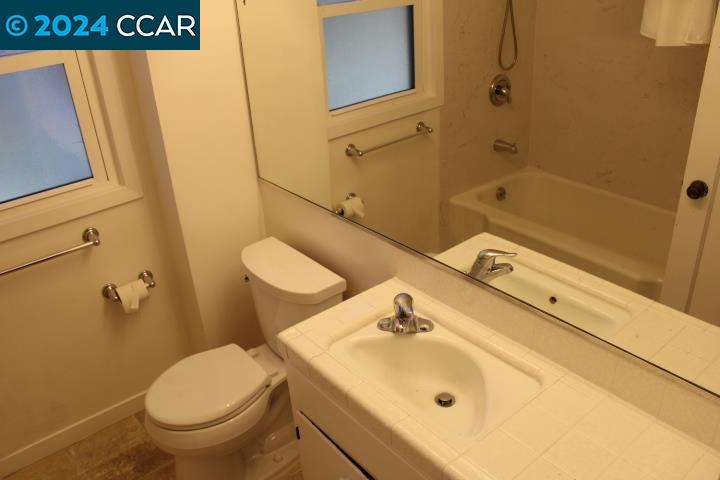 908 Everett Street El Cerrito, CA 94530 - Photo 16 of 27 a bathroom with a sink a toilet and shower