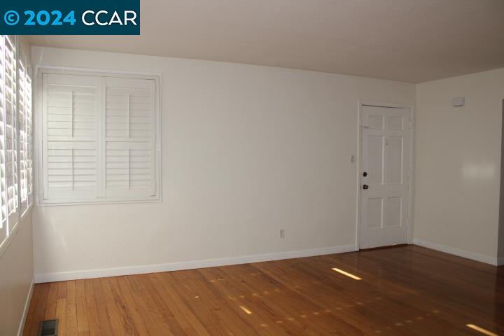 908 Everett Street El Cerrito, CA 94530 - Photo 3 of 27 a view of an empty room with wooden floor