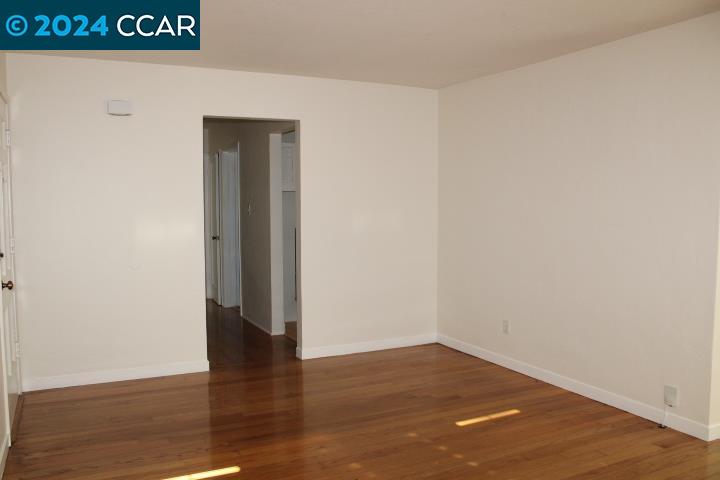 908 Everett Street El Cerrito, CA 94530 - Photo 4 of 27 a view of an empty room with wooden floor and a window