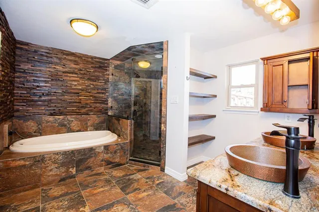 a bathroom with a granite countertop sink mirror vanity and toilet