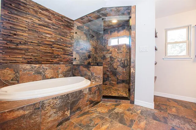 a bathroom with a bathtub and shower