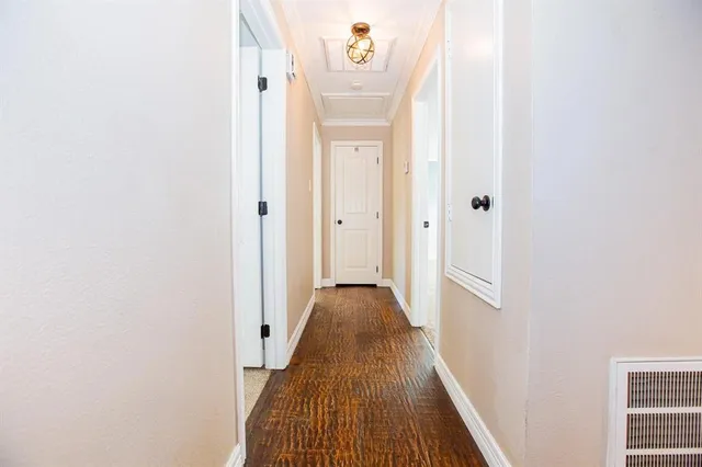 a view of a hallway with wooden floor and closet