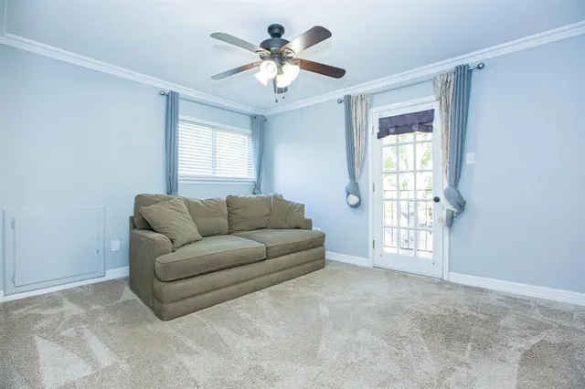 a living room with furniture and windows