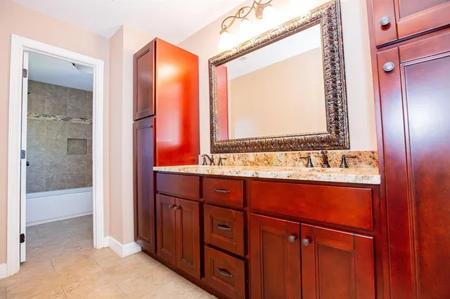 a bathroom with a sink and a mirror