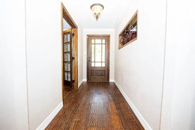 a view of a hallway with wooden floor