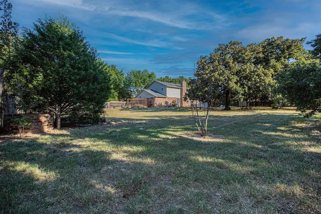a backyard of apartments with large trees