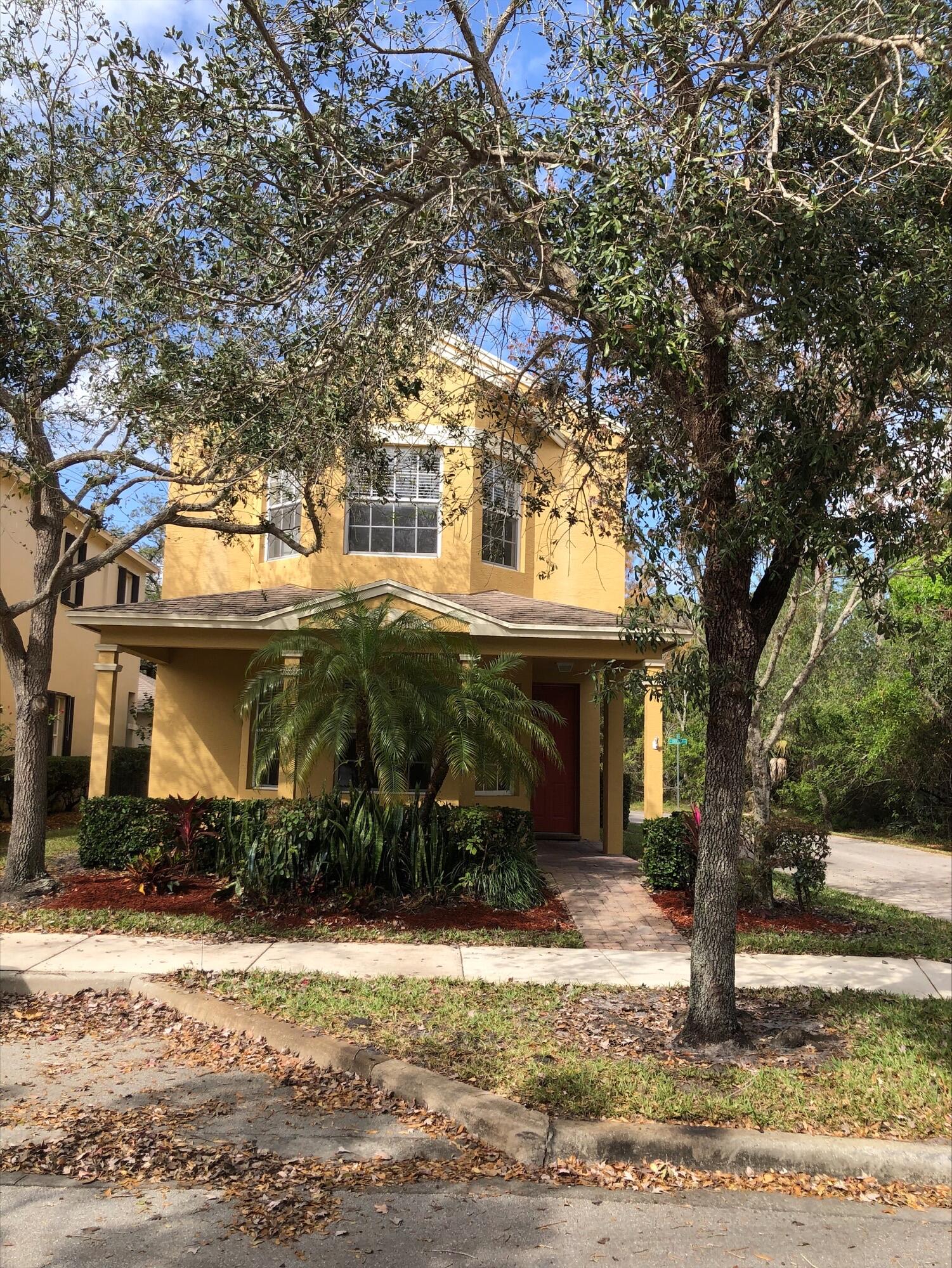 2031 Southeast Oldsmar Road Port St. Lucie, FL 34952 - Photo 1 of 14 a front view of a house with a yard and garage