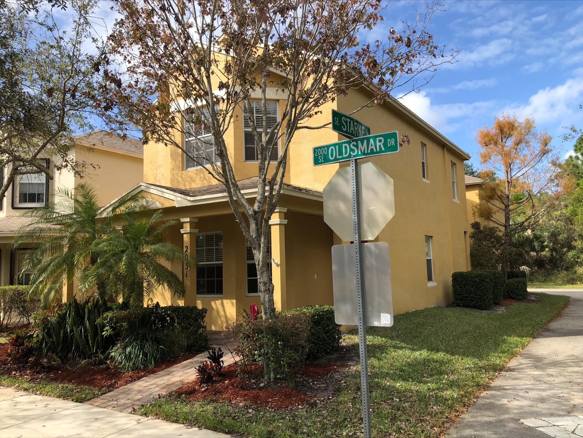 2031 Southeast Oldsmar Road Port St. Lucie, FL 34952 - Photo 2 of 14 a front view of a house with garden