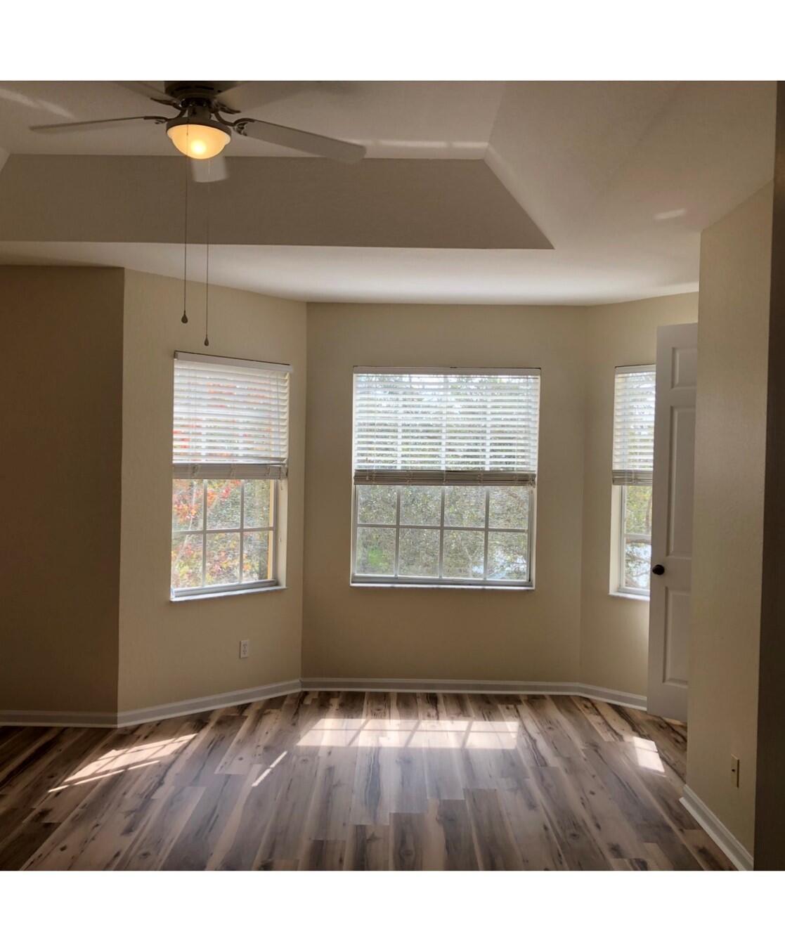 2031 Southeast Oldsmar Road Port St. Lucie, FL 34952 - Photo 8 of 14 a view of an empty room with wooden floor and a window