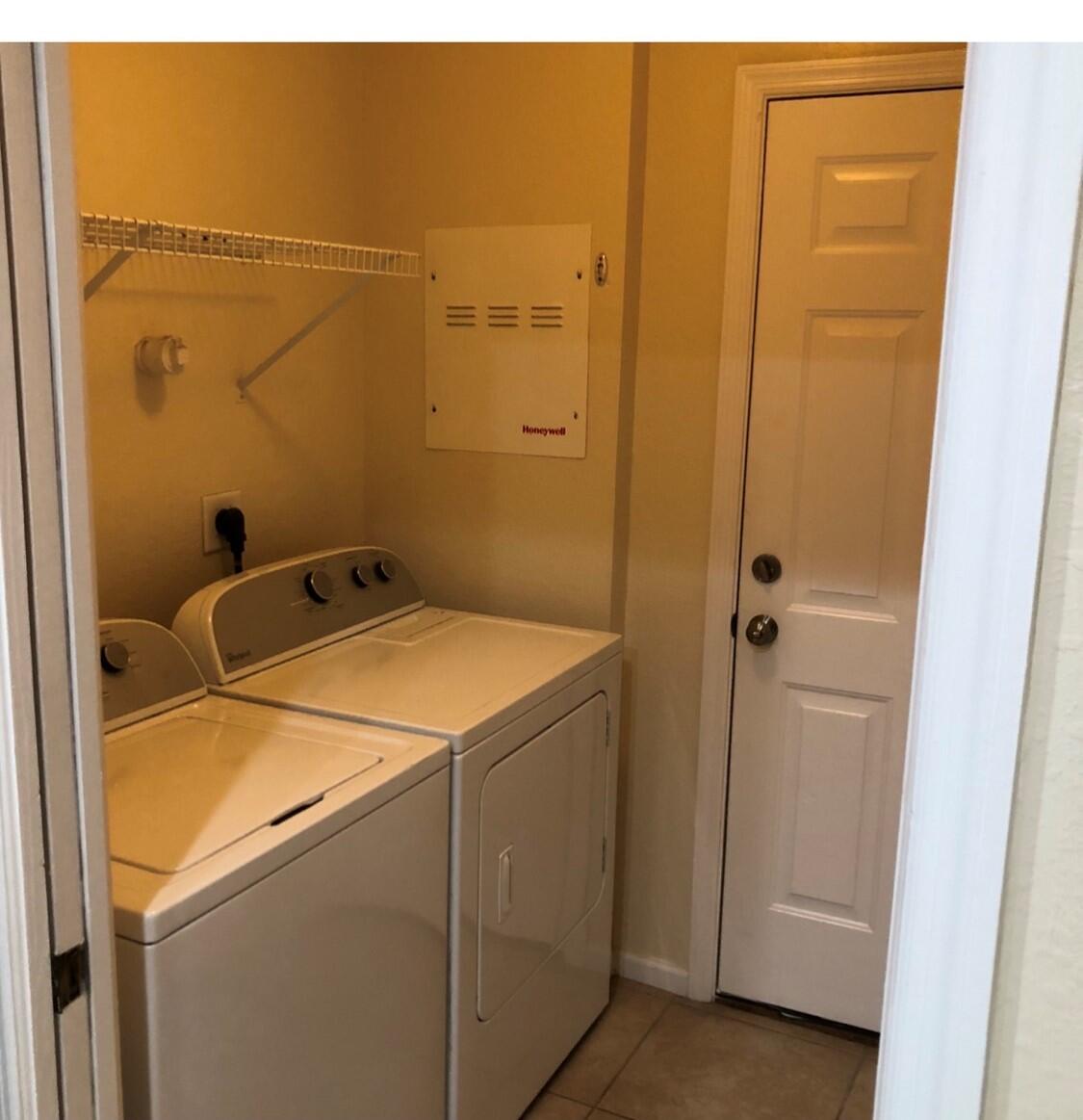 2031 Southeast Oldsmar Road Port St. Lucie, FL 34952 - Photo 9 of 14 a utility room with dryer and washer