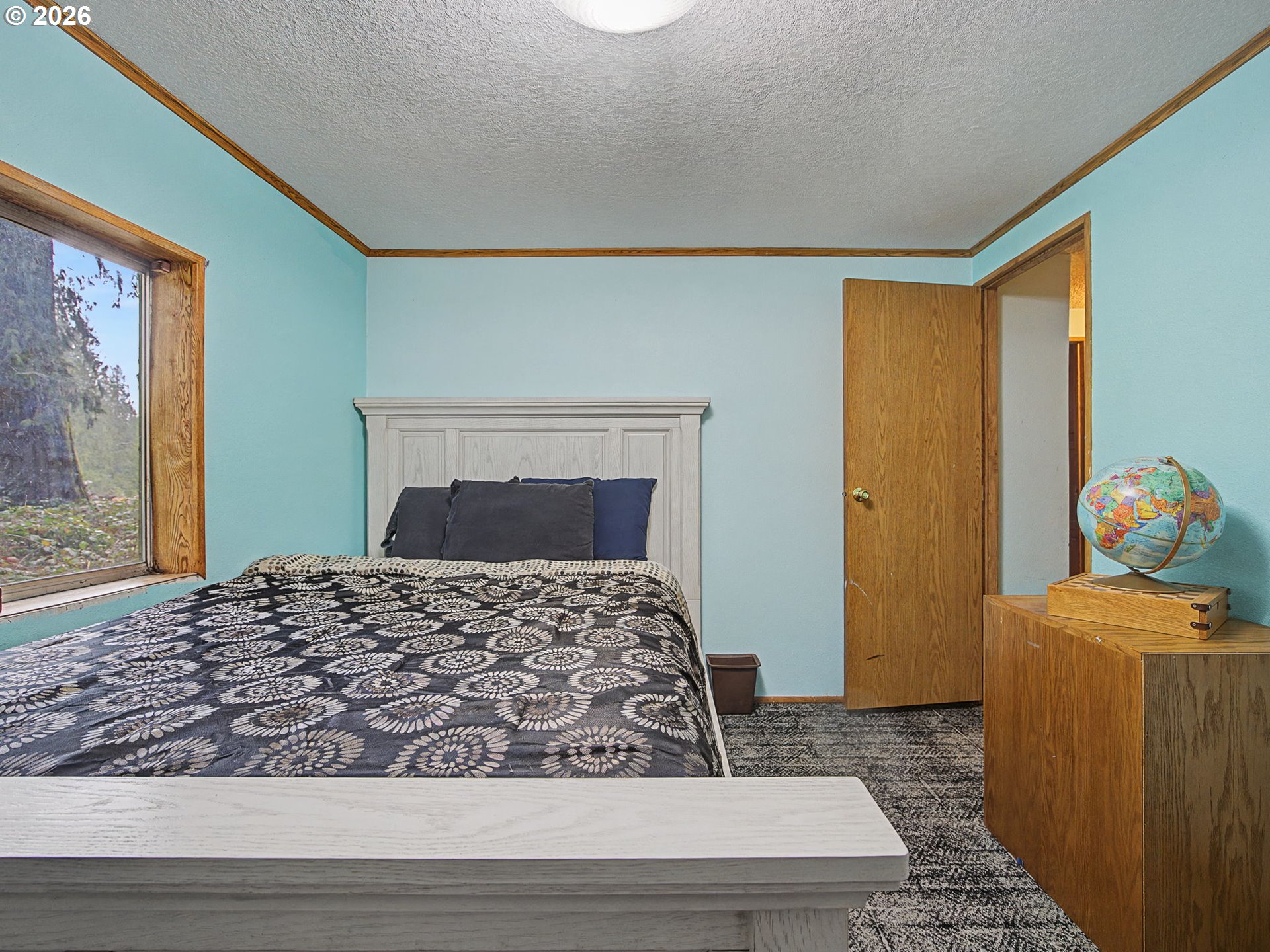 41180 Southeast Kubitz Road Sandy, OR 97055 - Photo 22 of 35 a bedroom with a bed and wooden floor