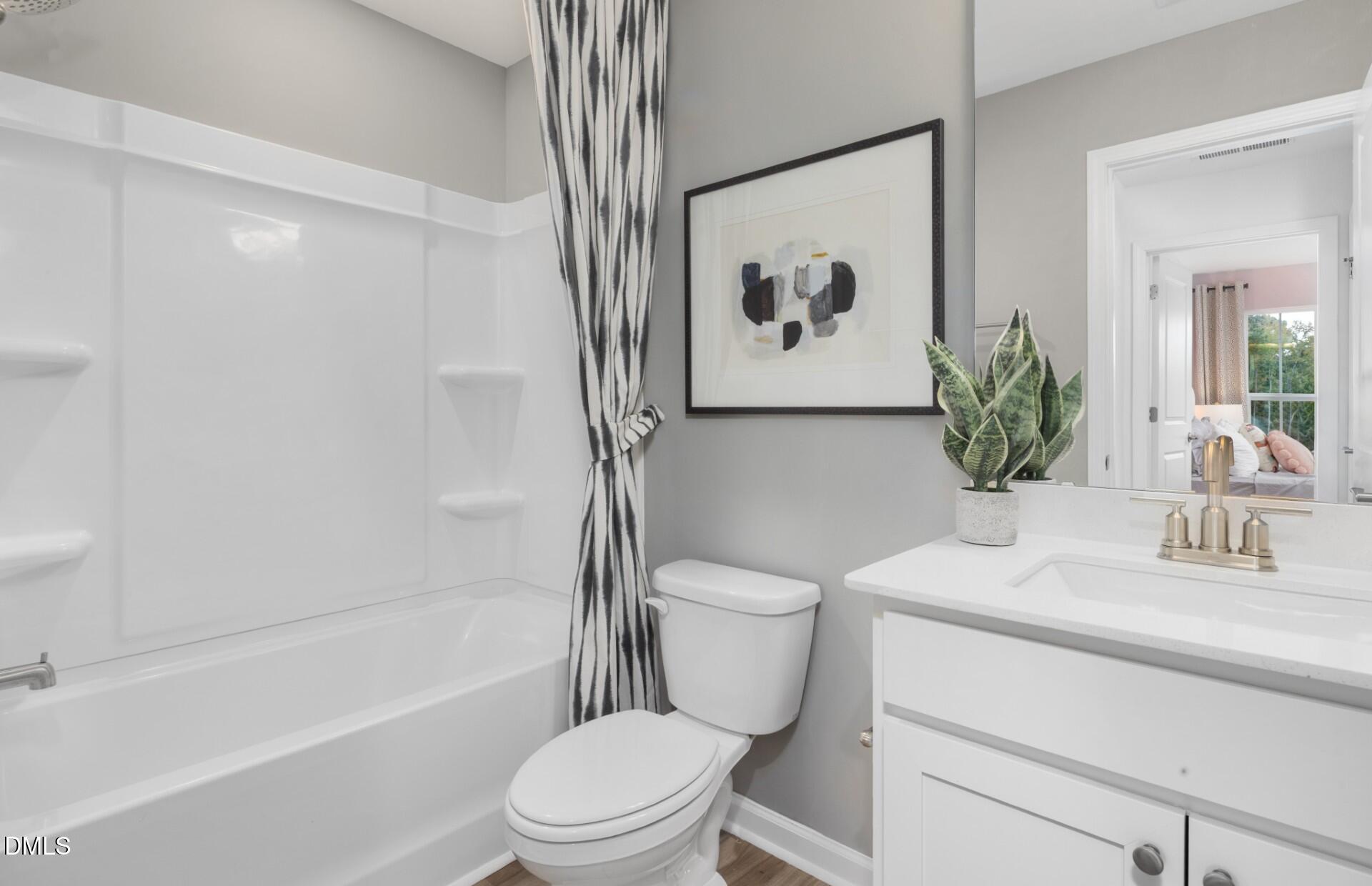 3017 Hammer Creek Road Durham, NC 27704 - Photo 17 of 18 a bathroom with a toilet sink and a bathtub