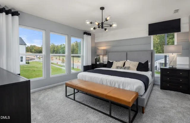 a bed sitting in a bedroom next to a window