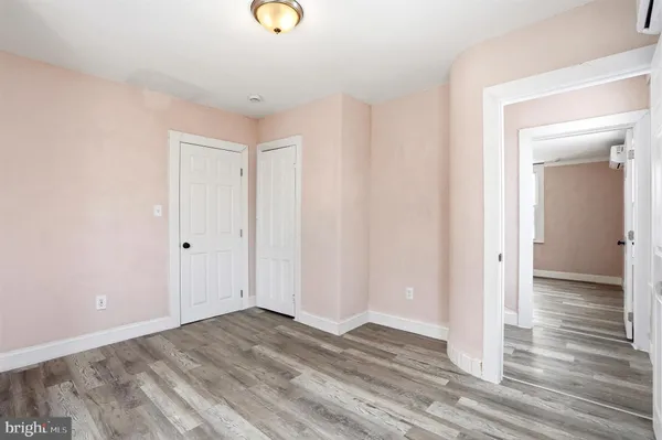 a view of a room with wooden floor