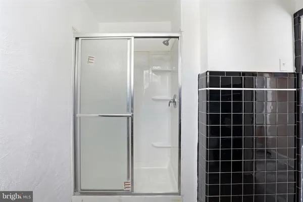 a bathroom with a glass shower door
