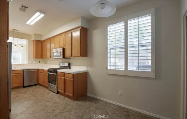 a kitchen with a stove sink and cabinets