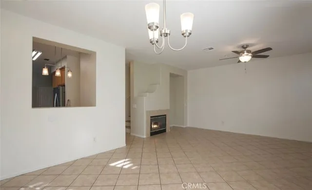 a view of a livingroom with a chandelier fan and furniture